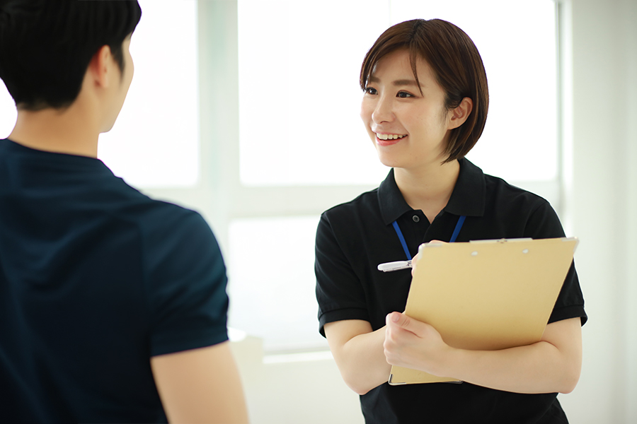 女性の公認スポーツ栄養士がアスリートに栄養指導をしている様子